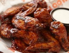 chicken wings with dipping sauce on the side