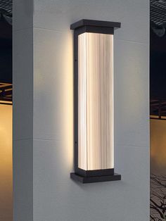 a wall mounted light on the side of a building