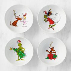 four plates with the grinch characters painted on them are sitting on a marble surface