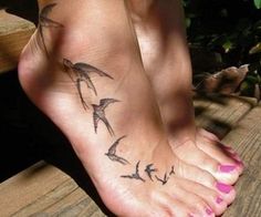 a woman's foot with birds on it