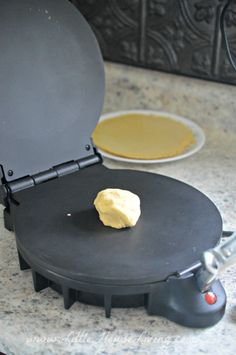 a panini maker with a piece of bread on it's side sitting on a counter