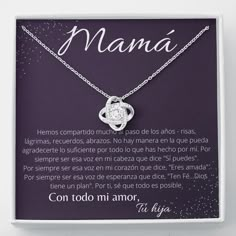 a necklace with the words mama written on it in spanish and an image of a heart