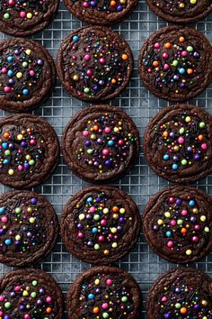 chocolate cookies decorated with sprinkles on a cooling rack, ready to be eaten