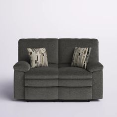 a gray couch with two pillows on it