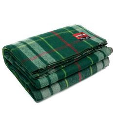 the green plaid blanket is folded on top of each other, with red and white stripes