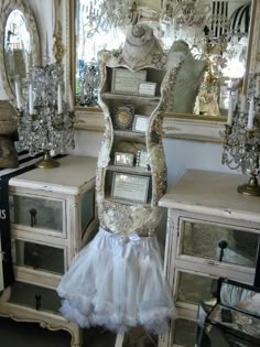 there is a chair that has been decorated in white and gold with a ruffled skirt on it