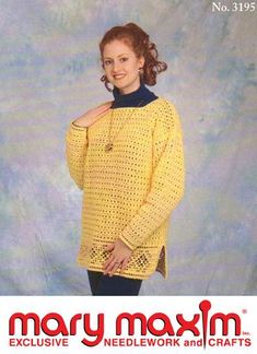 a woman wearing a yellow sweater and black pants with her hands on her hips, posing for the camera