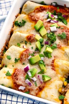 an enchilada casserole with meat, cheese and avocado