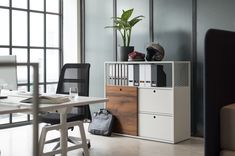 an office area with desk, chair and computer