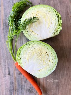 two lettuce halves with carrots on a wooden surface