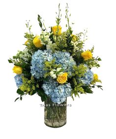 a vase filled with blue and yellow flowers