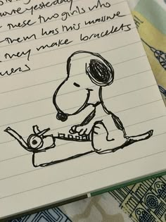 a notepad with a drawing of a dog on it and a handwritten quote