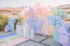 an outdoor party with balloons and decorations