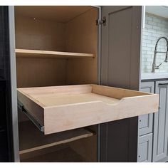 an open cabinet door in a kitchen