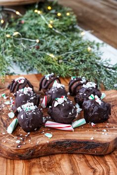 chocolate covered candy canes on a cutting board