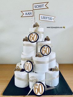 a cake made out of toilet paper with the number 60 on it and some decorations