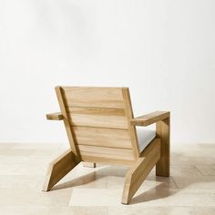 a wooden chair sitting on top of a tile floor