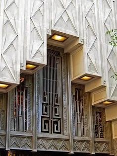 an art deco building with decorative windows and doors