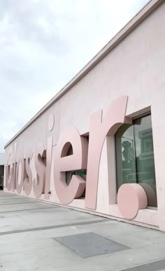 a pink building with the word aussier on it's side and windows