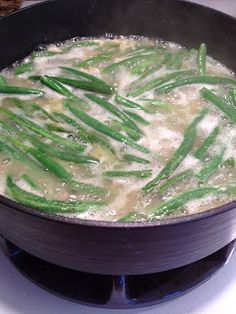 green beans are being cooked in a pan on the stove