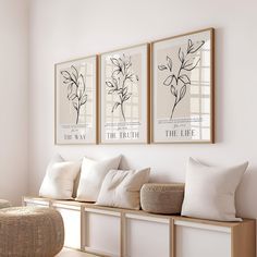 three framed pictures hang on the wall next to a bench with pillows and a wicker basket