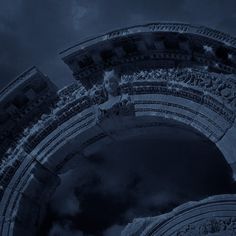 the reflection of a statue in an arch on a cloudy night with dark clouds behind it