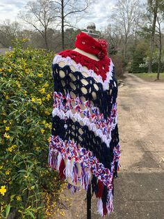 "70's Ponchos/Hippie Ponchos/Boho Ponchos/Lightweight Ponchos/Multi Ponchos/70's Vintage Ponchos/Vintage Ponchos/NEAR MINT CONDITION 1970's Red/White/Blue Handmade Poncho Hippie Boho Poncho Handmade Crocheted Lightweight Poncho This is a Great Long Length of 34\" from just Below the Neck. Measurements - Bust (entire width) - 52\" Length - 34\" from just below the Neck to the Longest Point in the Center NEAR MINT CONDITION - The Colors in this Poncho are Beautiful! It is listed as near mint condi Red Bohemian Poncho With Fringe, Red Bohemian Poncho For Festival, Red Bohemian Poncho Cape, Red Cape Poncho For Festival, Red Bohemian Cape Poncho, Red Bohemian Shawl Cape, Bohemian Red Cape For Festivals, Hippie Shawl Poncho For Festivals, Bohemian Poncho Cape One Size