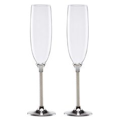 two wine glasses sitting side by side on top of each other with silver rims