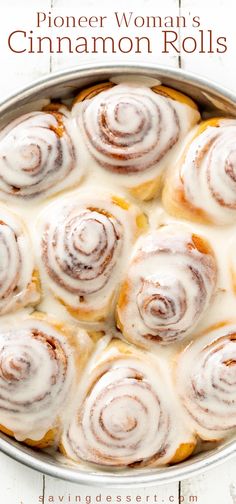 a pan filled with cinnamon rolls covered in icing