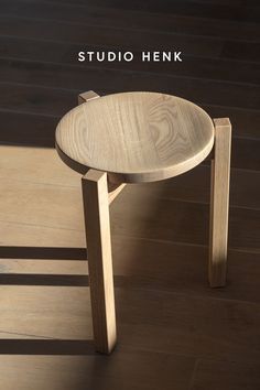 a small wooden stool sitting on top of a hard wood floor