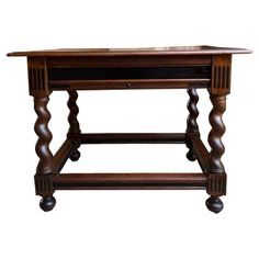 an antique wooden table with turned legs