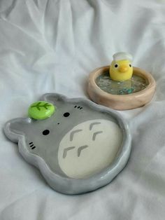 two rubber ducks in a bowl with water