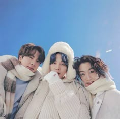 three young women in winter clothes posing for the camera