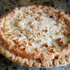 a pie sitting on top of a table covered in toppings