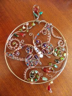 a metal wire and glass decoration on a wooden table