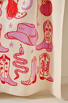 a white towel with pink and red images on it, including cowboy boots and stars