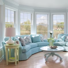 a living room filled with furniture and windows