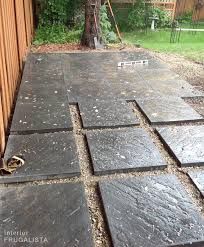 an outdoor patio being constructed with slate tiles