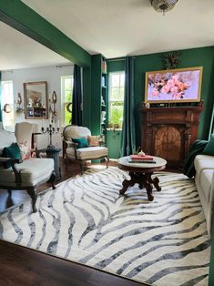 a living room filled with furniture and a flat screen tv on top of a fireplace