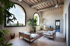 a living room filled with furniture and a large window