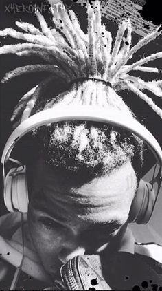 a young man with dreadlocks wearing headphones