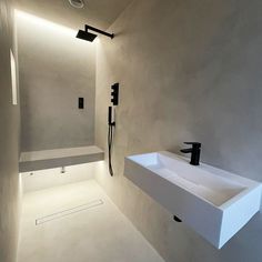 a bathroom with a white sink and black faucet