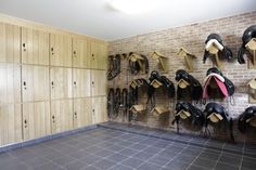 a room filled with lots of different types of hats hanging on the wall next to lockers