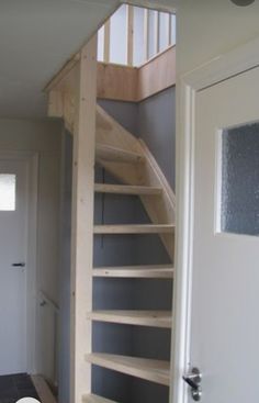 there is a wooden stair case next to the door