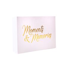 a greeting card with the words moments and memories on it in gold foil lettering, against a white background