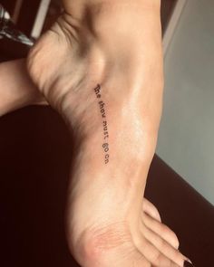 a woman's foot with a tattoo that reads, i love you to the moon and back