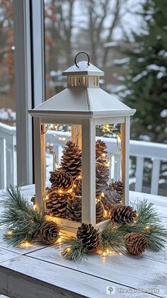 a lantern with pine cones and lights on it