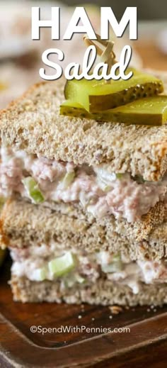 ham salad sandwich with pickles on a cutting board