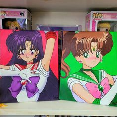 three boxes with anime characters on them are sitting on a shelf next to each other