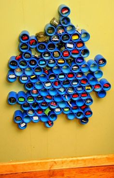 a pile of blue cups sitting on top of a yellow table next to each other